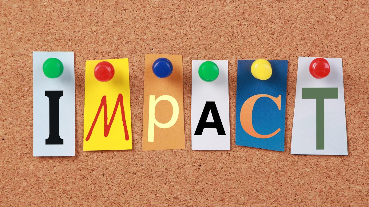 Letters on cork board spelling out IMPACT