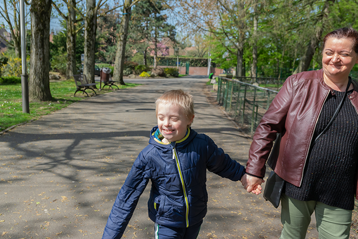 family-support-services Mother and child walking hand in hand in park
